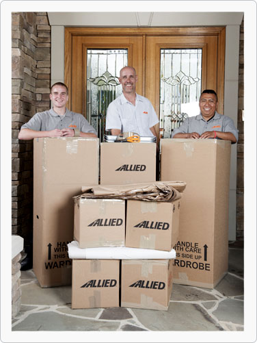 Moving company driver, packers and helpers with moving boxes and materials