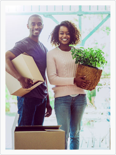 Couple moving with plants