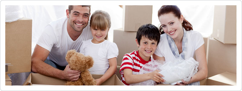 Parents and children packing boxes for moving