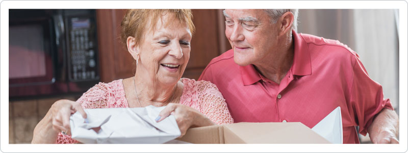Senior couple packing kitchen for a move