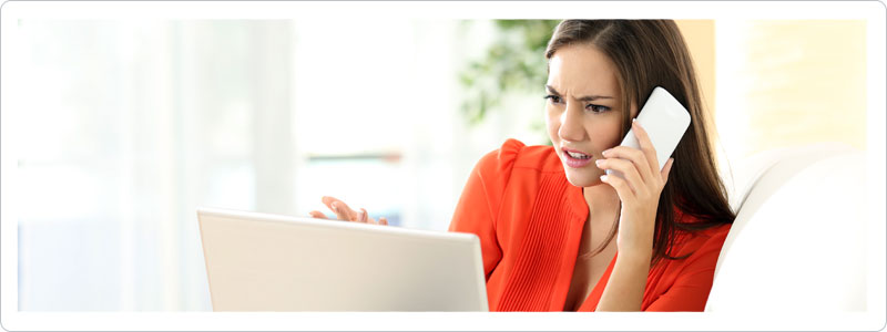 Woman on computer reading about common moving scams