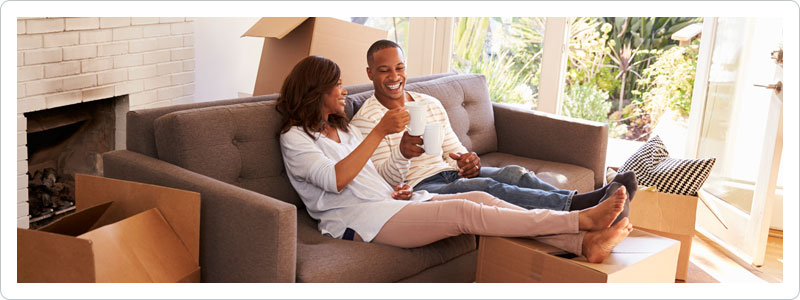 Couple taking a break from unpacking the first night after a move