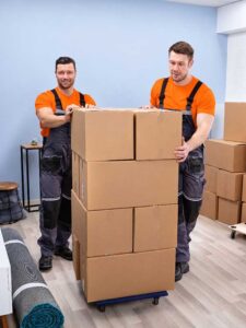 Two men packing moving boxes in a residential home